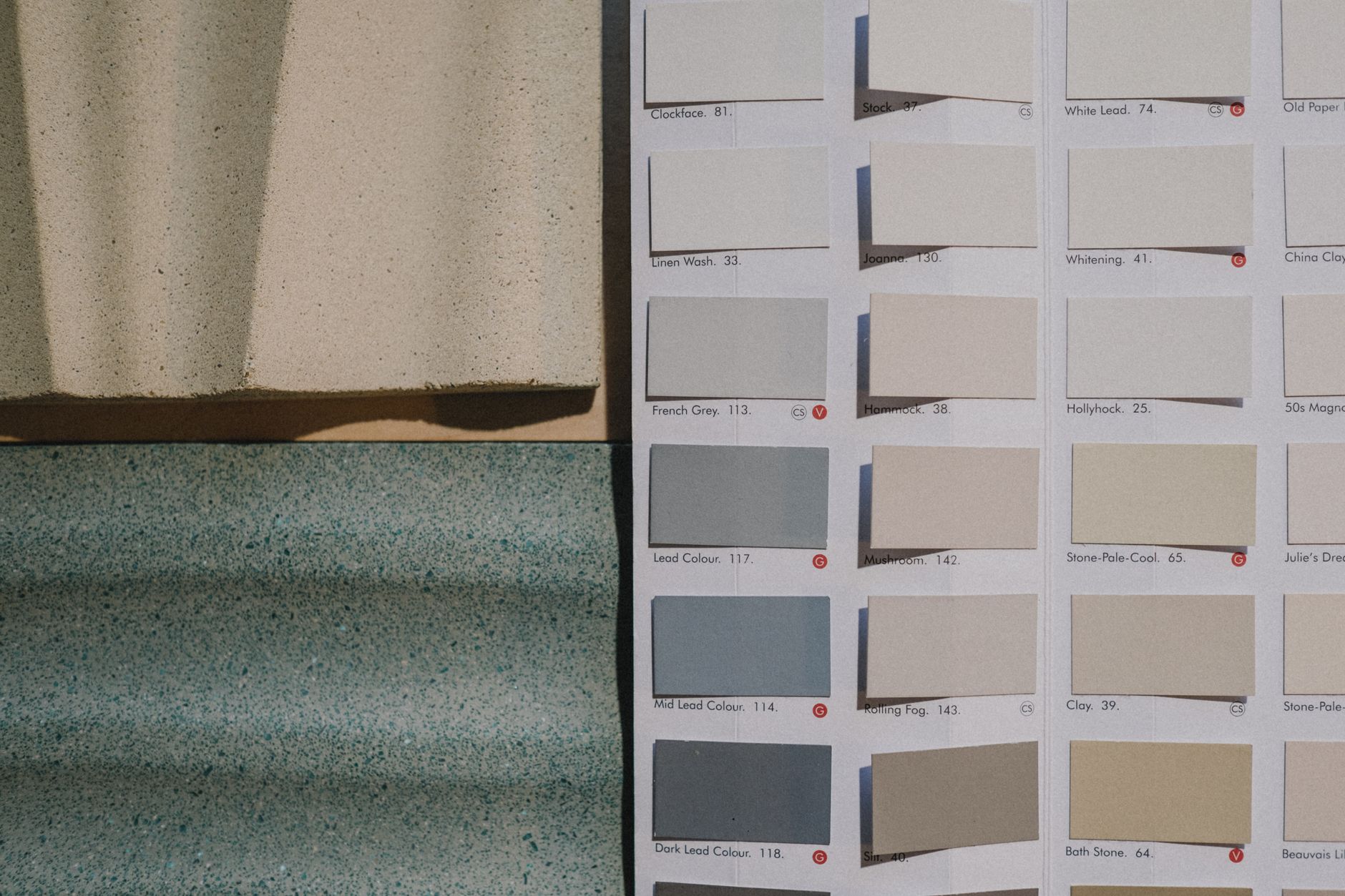 A detailed view of paint color swatches alongside textured material samples for design inspiration.