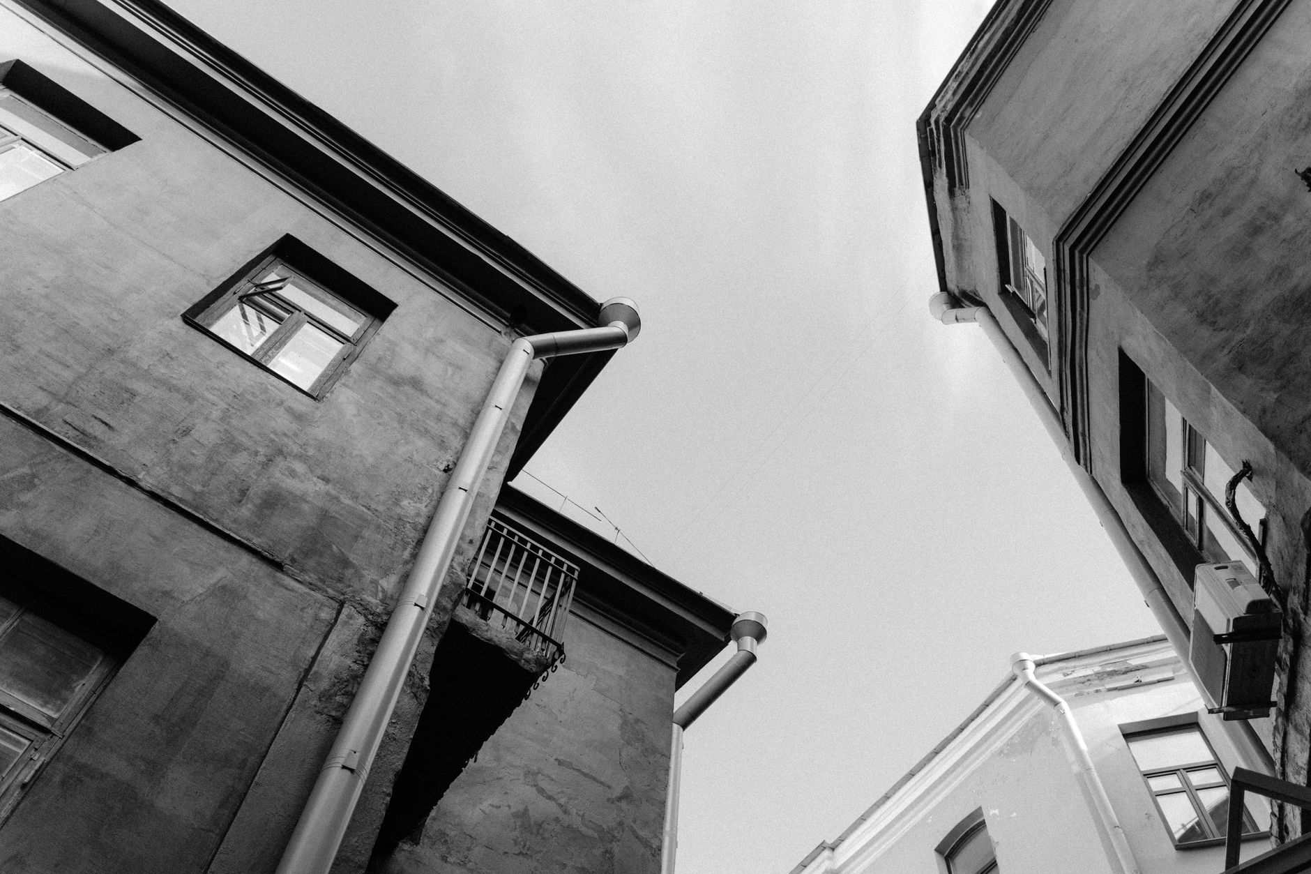 A low angle shot of urban buildings with a vintage architectural style in black and white.