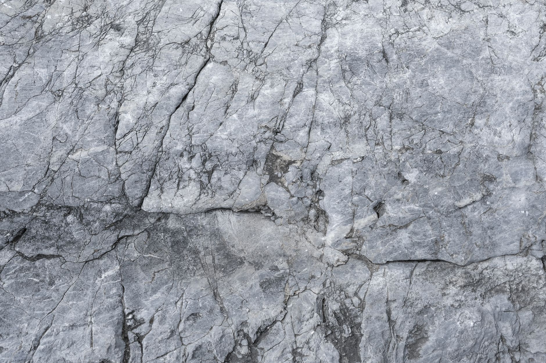 High-resolution close-up image showcasing the intricate texture of natural stone with visible cracks and patterns.