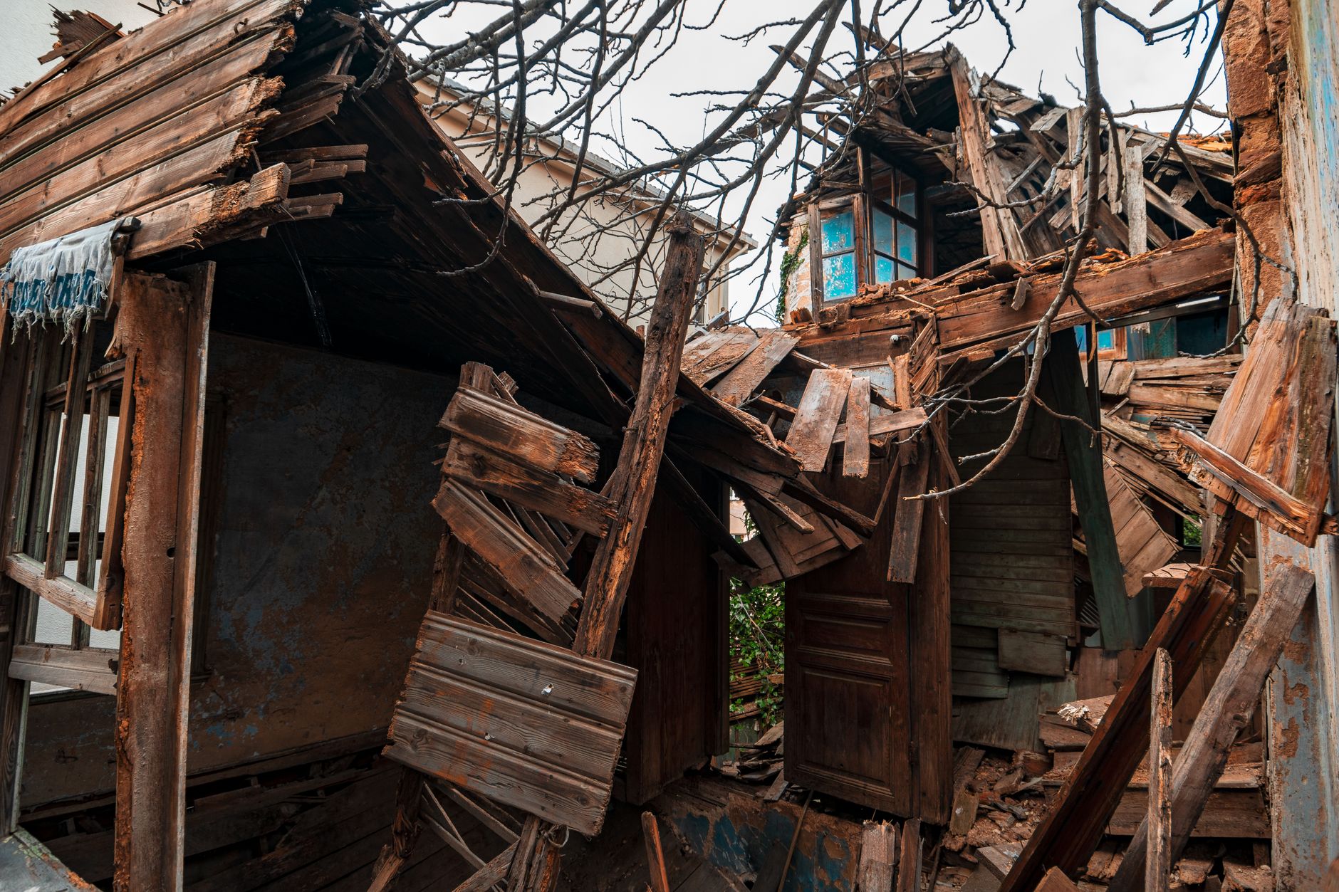 Close-up of a damaged, abandoned wooden house in Üsküdar, showcasing intricate architectural decay.